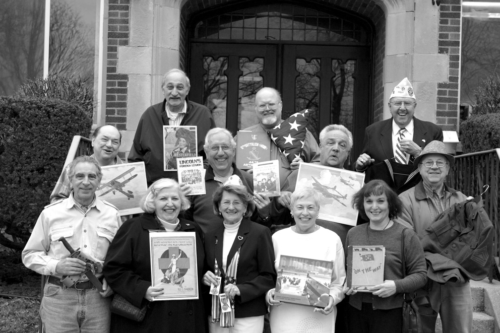 Members of the Italian American Veterans Museum and Library Committee show off some of the artifacts that will be on display at the grand opening. 