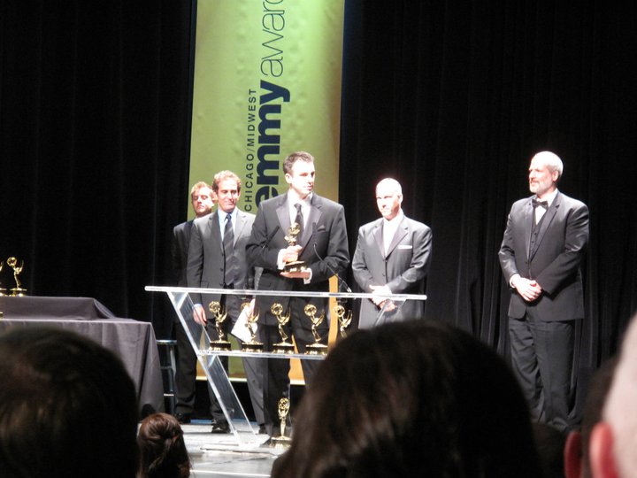 Jim Distasio accepts a Midwest Emmy for the documentary "5000 Miles From Home" as fellow honoree Paul Basile (right) looks on with pride.